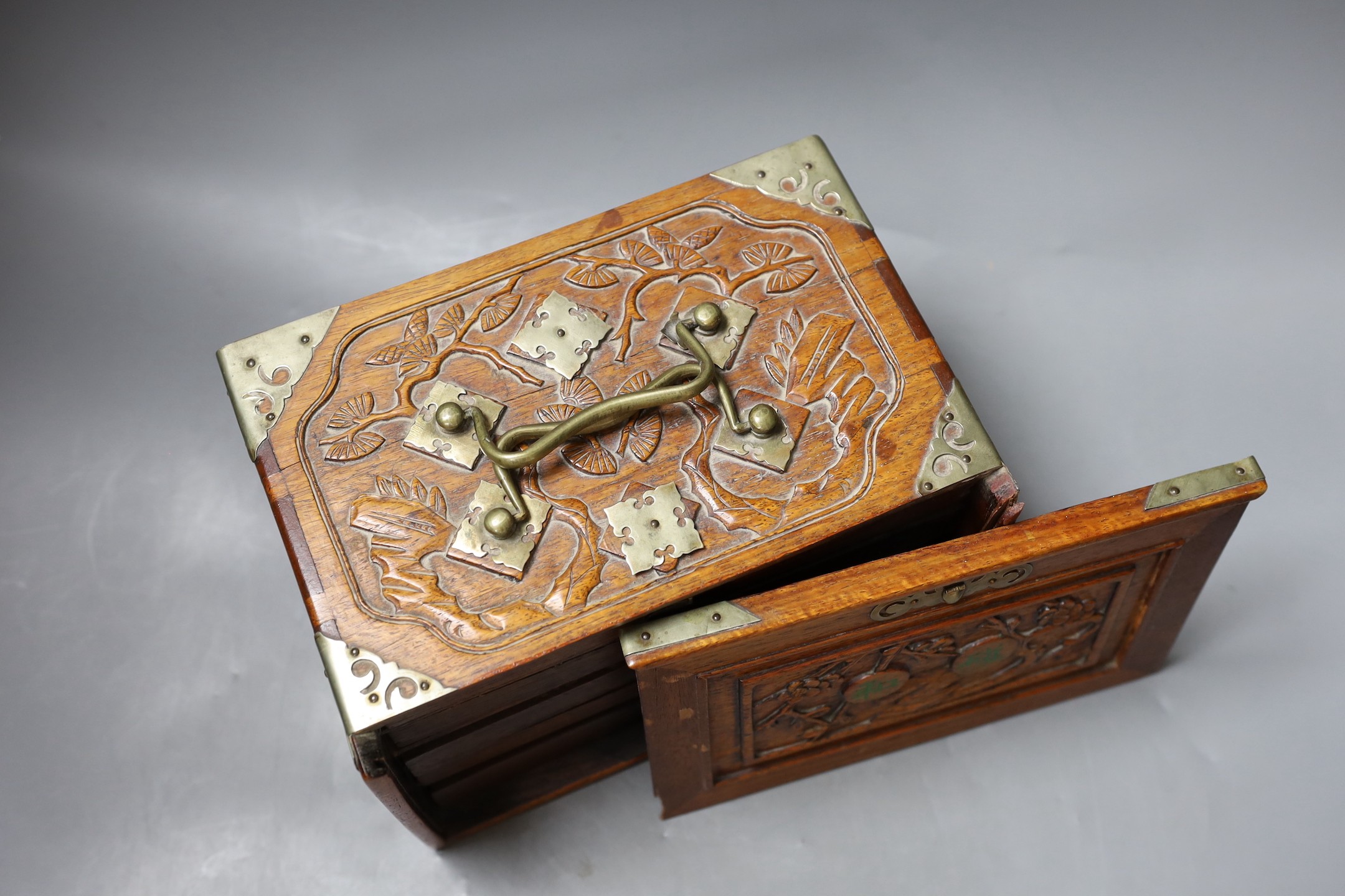 An early 20th century Chinese hardwood cased bone and bamboo mahjong set
